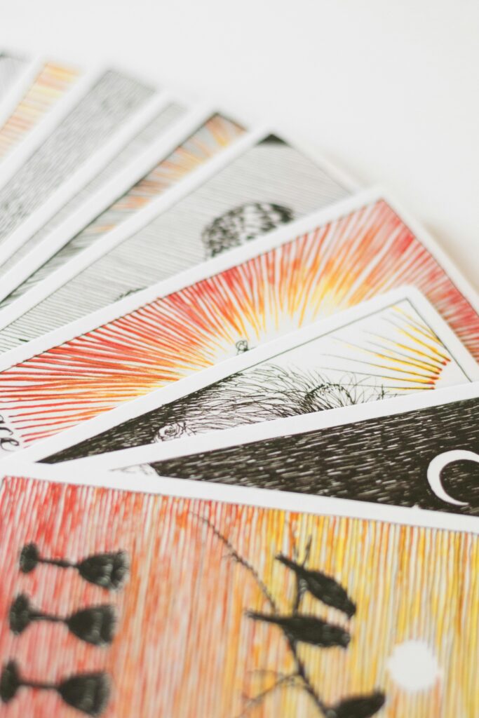 A close-up of colorful tarot cards on a white background, perfect for spiritual and divination themes.