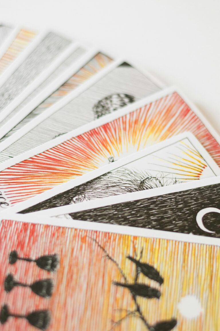 A close-up of colorful tarot cards on a white background, perfect for spiritual and divination themes.